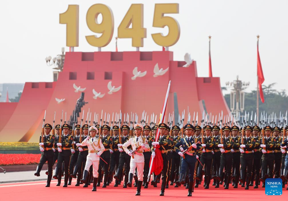 Chinese soldiers in ceremonial uniforms march in sync under a giant “1945” display with white doves, commemorating World War II victory | PMN Patralok