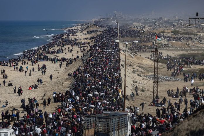 Thousands of Palestinians walk along the Gaza coastline as Israel orders a mass evacuation from northern Gaza, amid intensified airstrikes and warnings of a broader ground offensive.